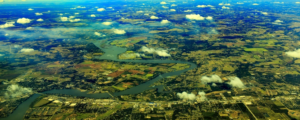 Aerial view of Lake Texoma showing winding shoreline, open water, and surrounding landscape in Texas and Oklahoma